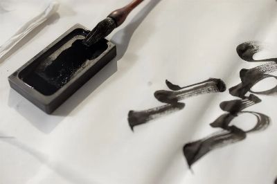 Close-up of traditional calligraphy ink and brush, illustrating artistic expression.