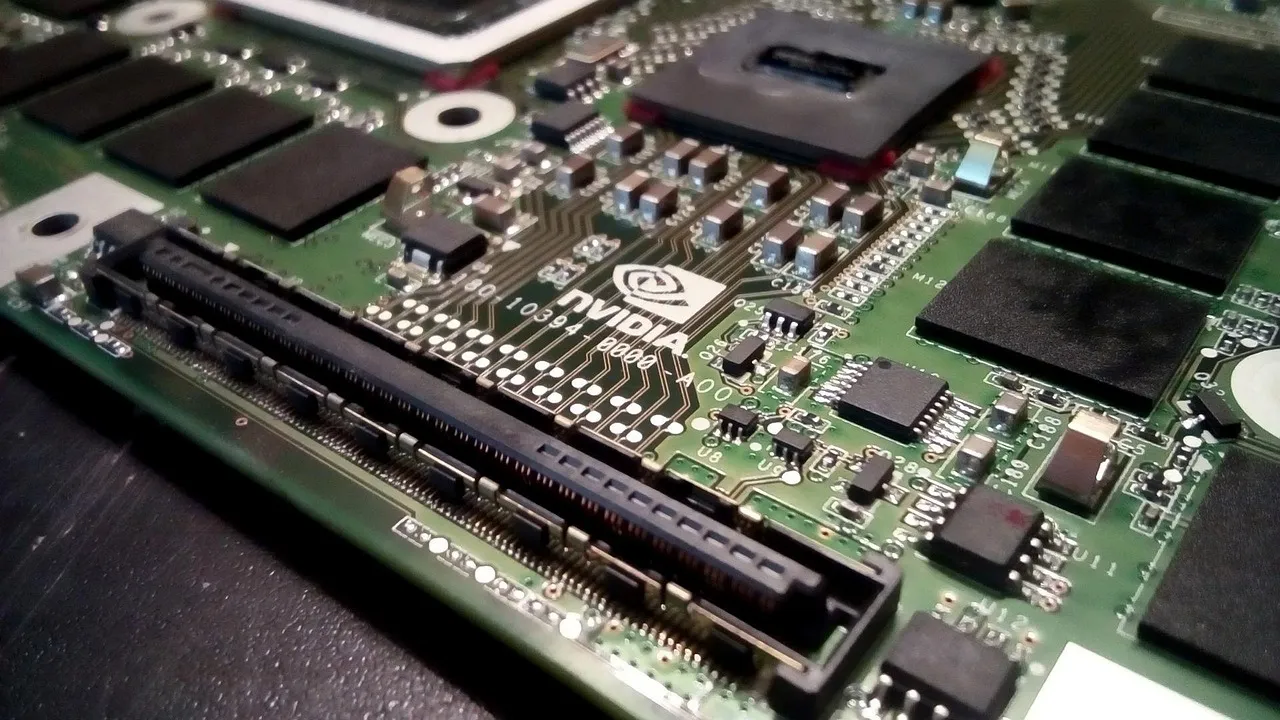 A close-up of a computer board showing a large processor package beside empty memory slots.