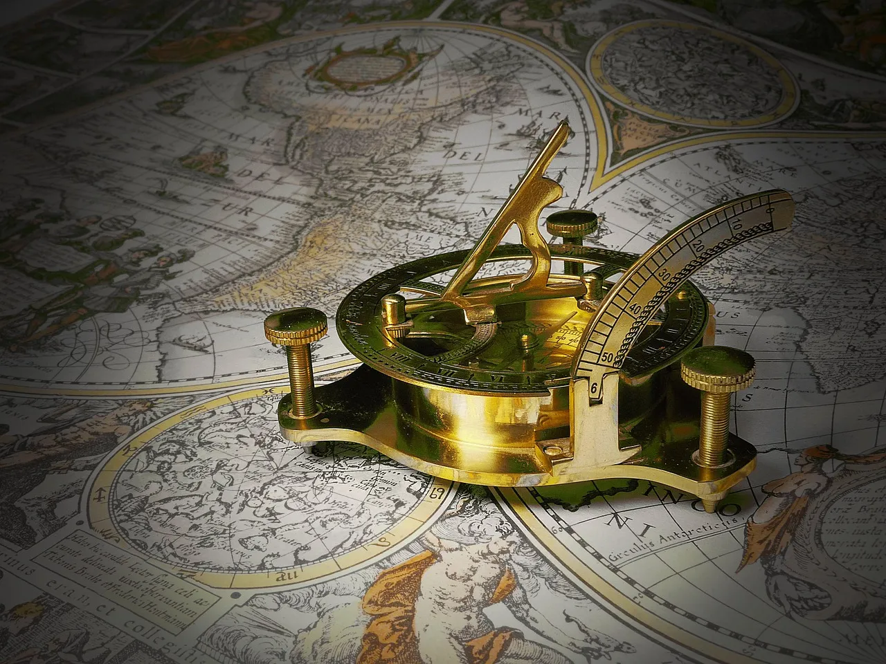 A brass sundial standing on an old printed map