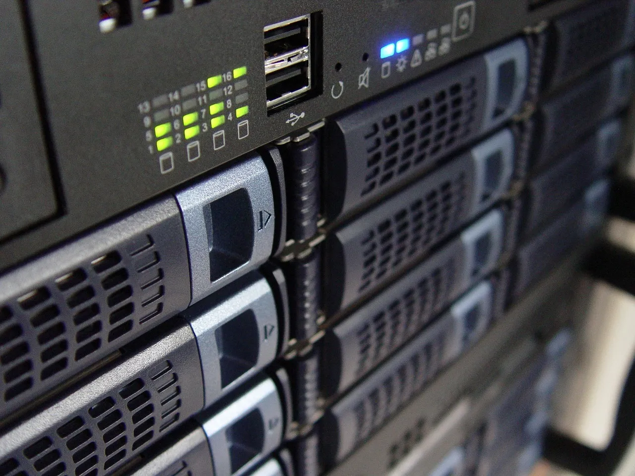 Front panels of rack-mounted servers with status indicators lit, illustrating a report on an ASEAN AI data centre partnership.