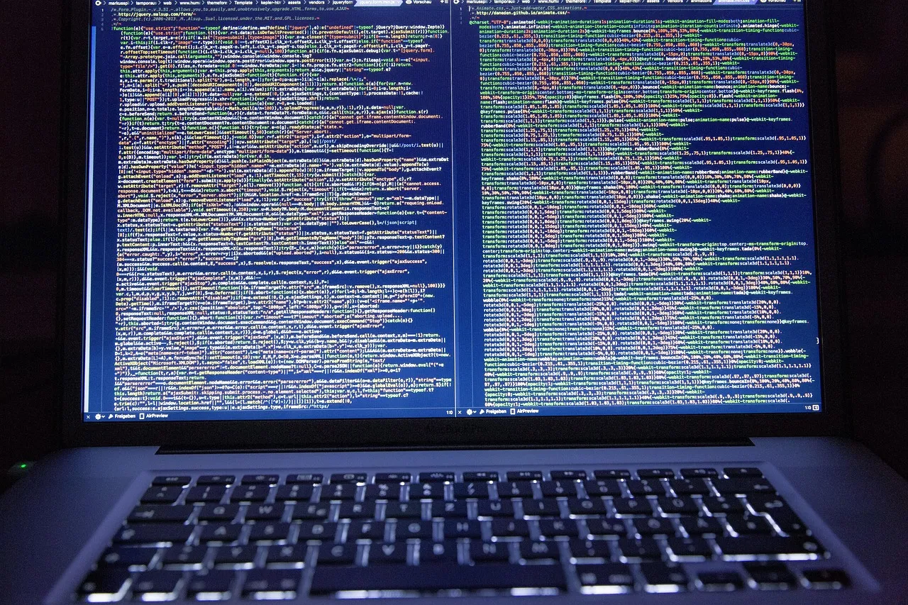 A laptop screen showing two panes of source code side by side