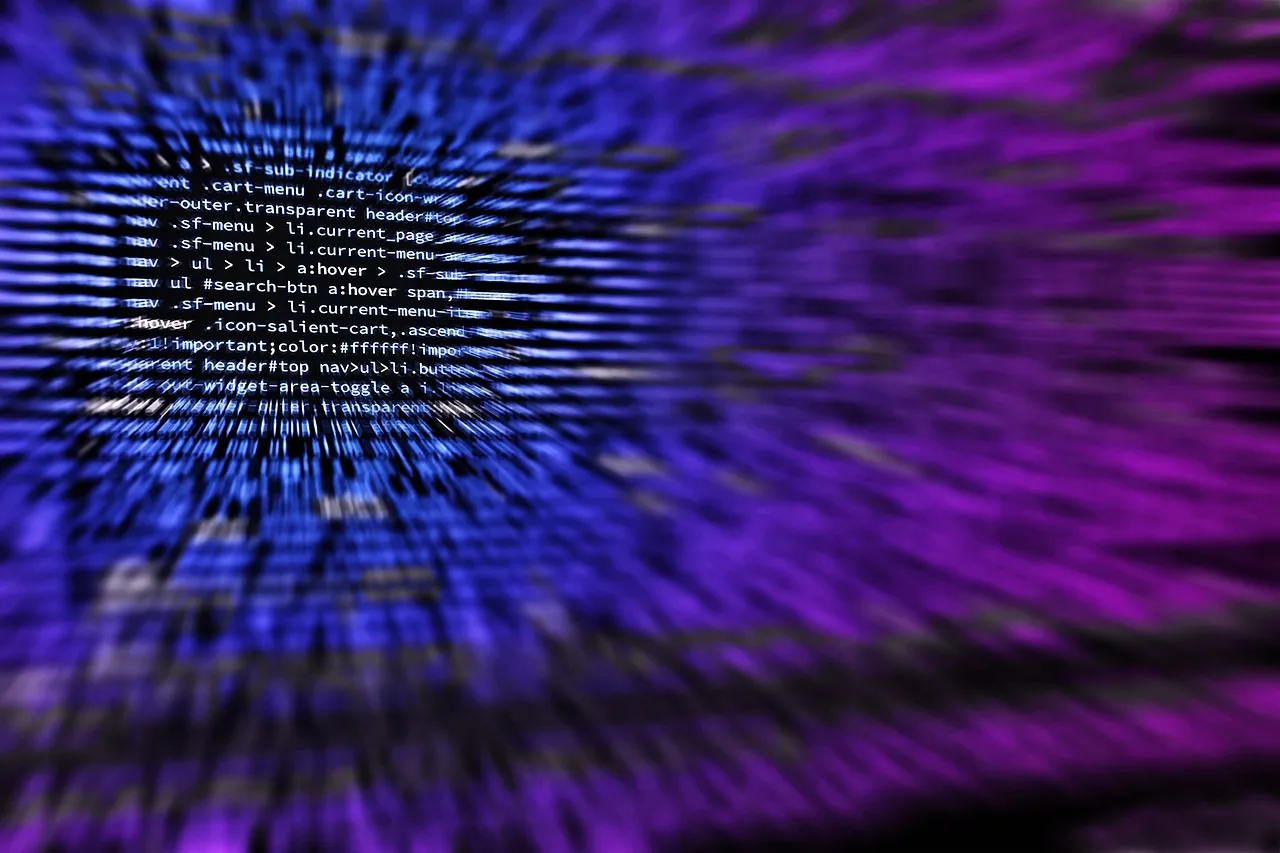 Lines of code on a dark screen in blue and purple, blurred outward from the centre