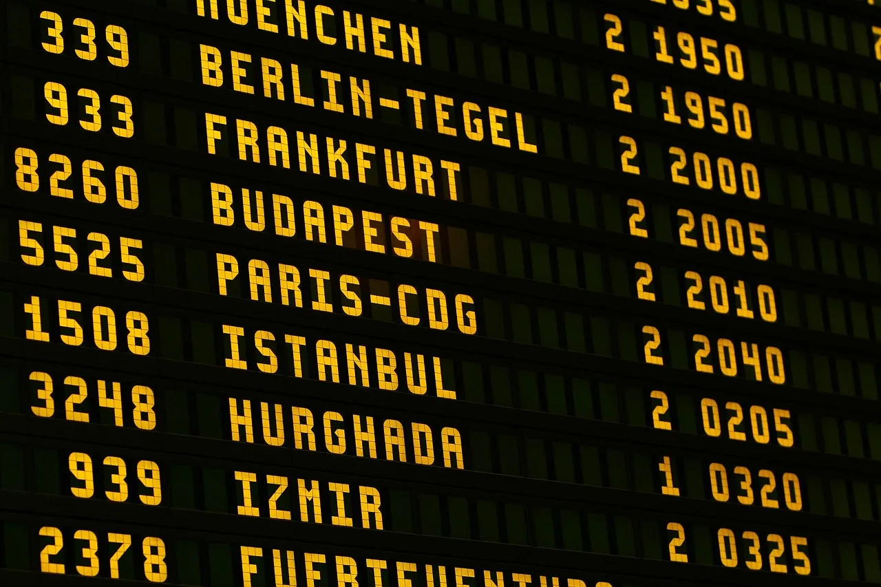 A split-flap departures board listing European cities and flight times