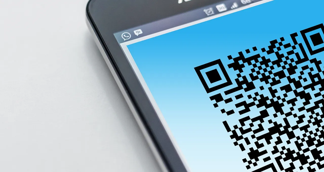 A tablet screen displaying a black-and-white QR code