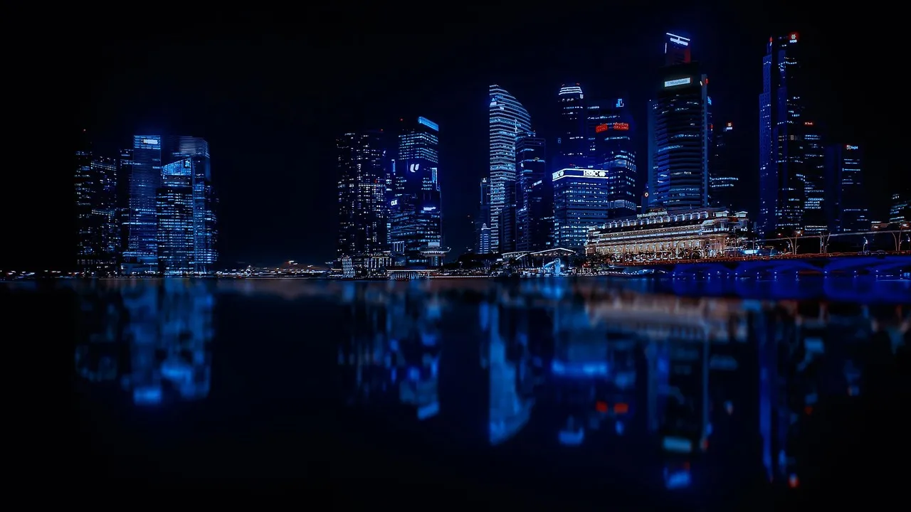 Singapore's modern skyline reflected in the water at night.