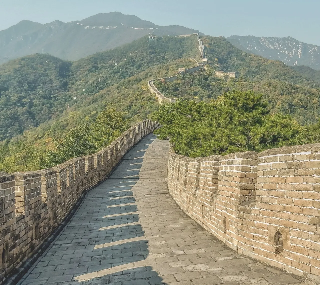 A section of the Great Wall of China winding across the hills.