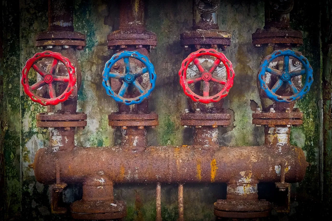 Industrial pipework and valves, illustrating the treatment plant equipment these controllers operate.