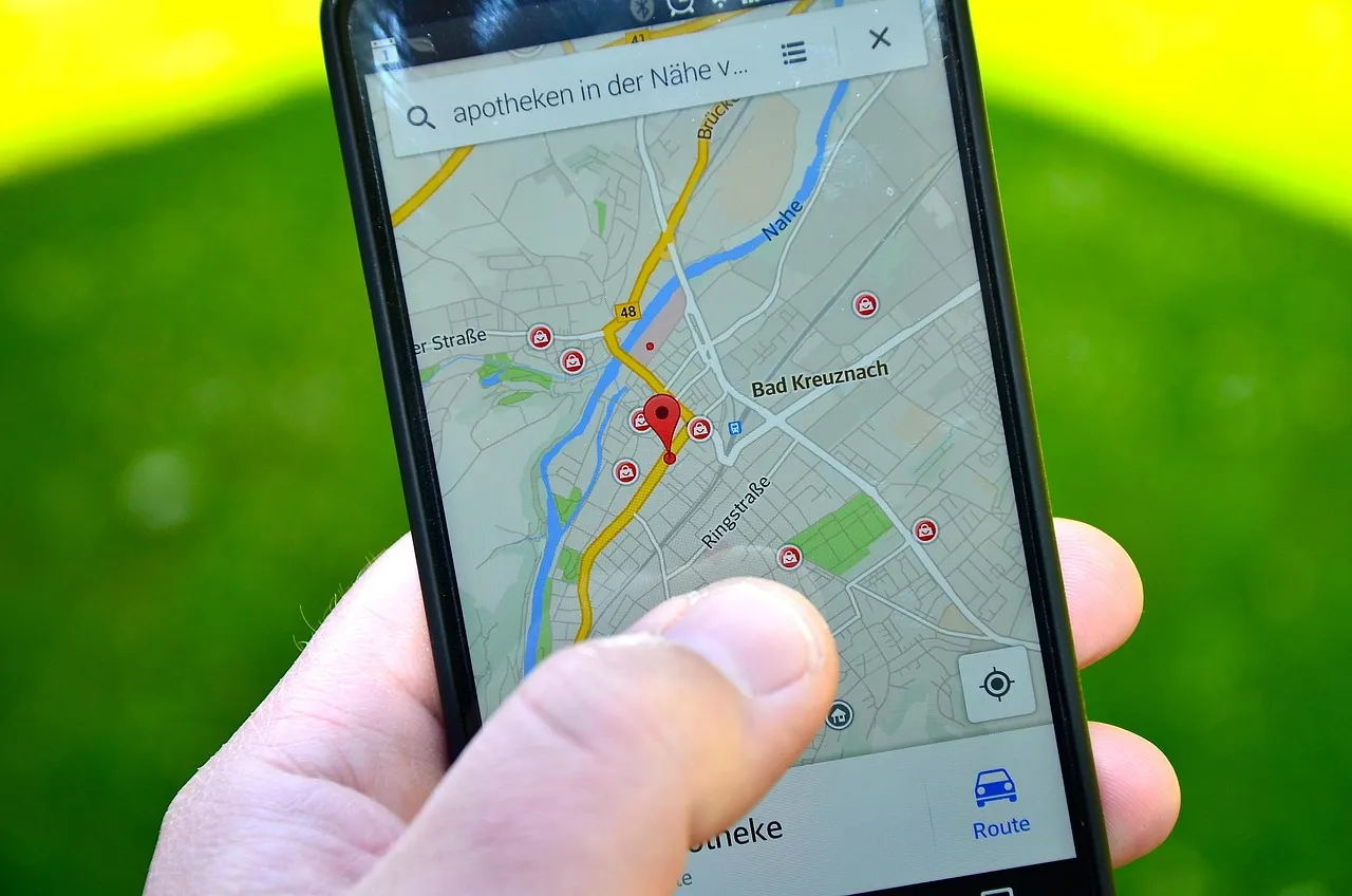 A hand holding a phone showing a map with a location pin, representing the location data the HMD Fuse flaw could expose