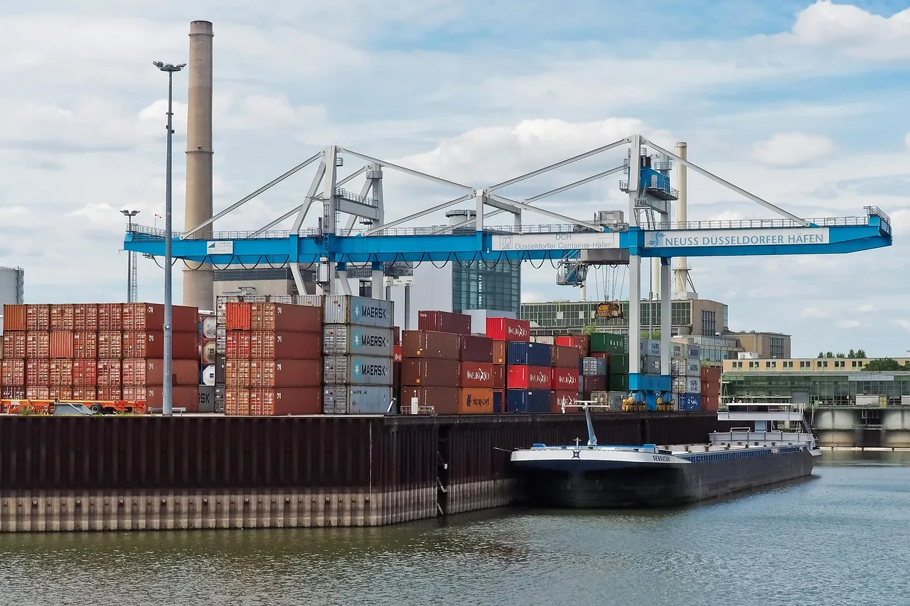 Container cranes and stacked shipping containers at a port
