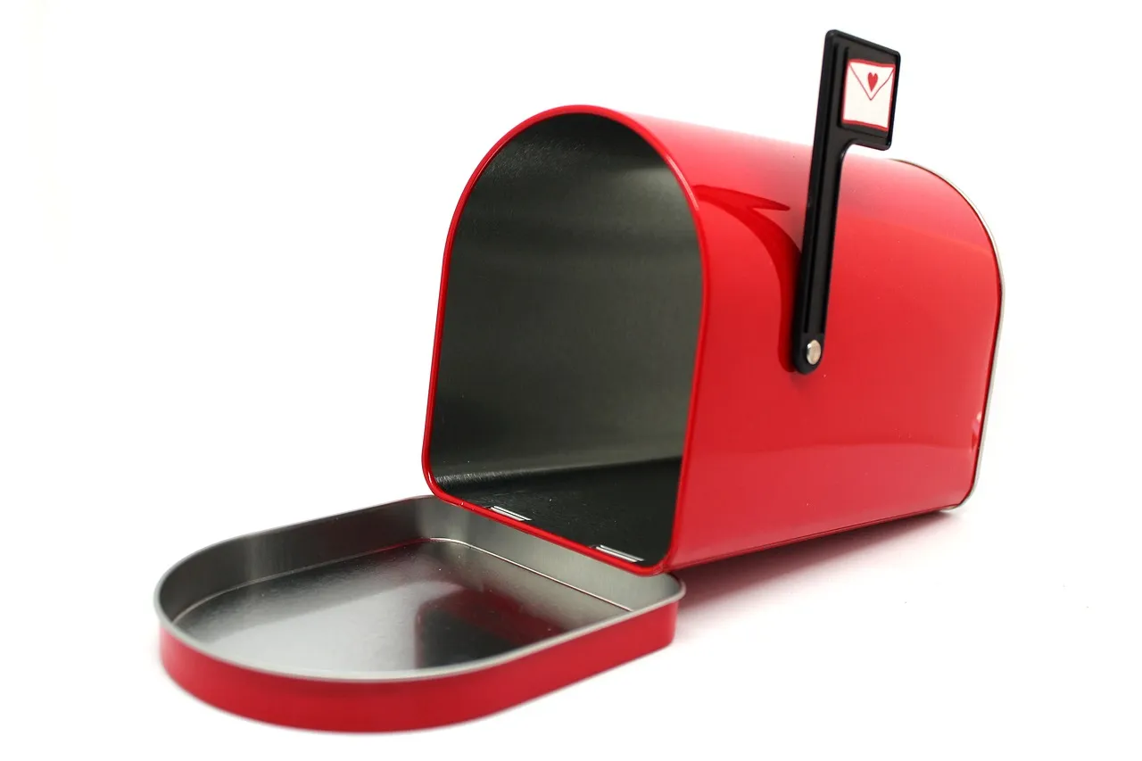 An open, empty red mailbox on a white background — illustrating a connected inbox read without its owner seeing it happen.