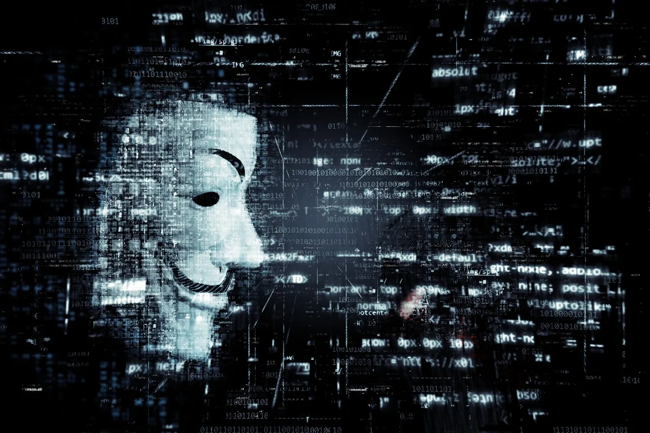 A figure wearing an anonymous mask against a dark background.