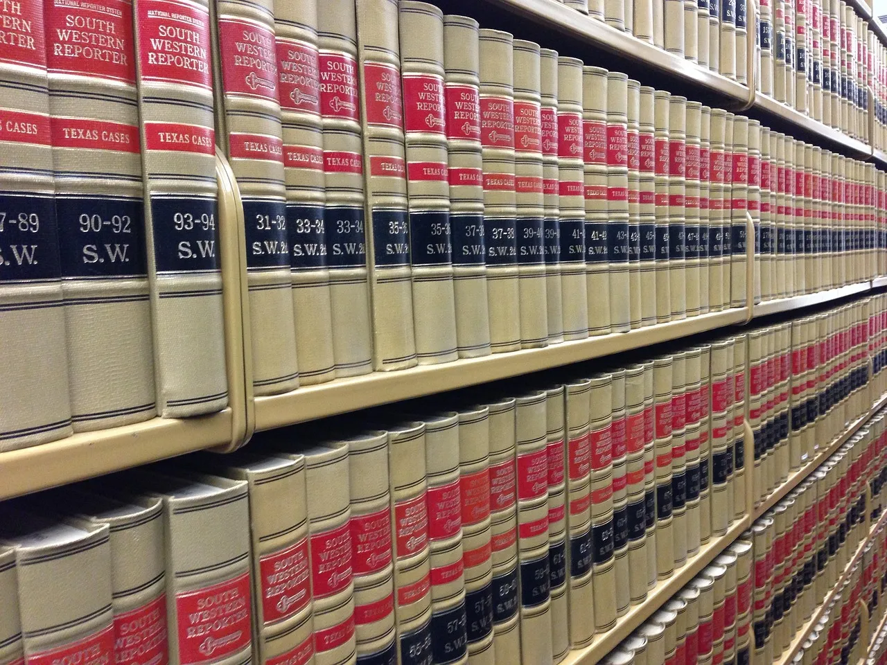 Rows of bound law reports packed tightly on wooden library shelves