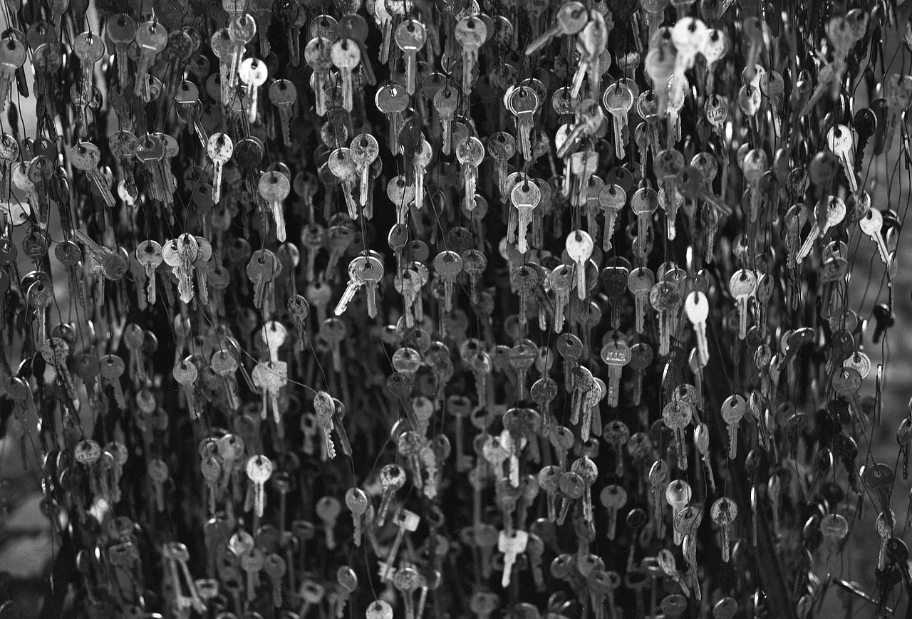 Hundreds of old metal keys packed densely together, filling the whole frame
