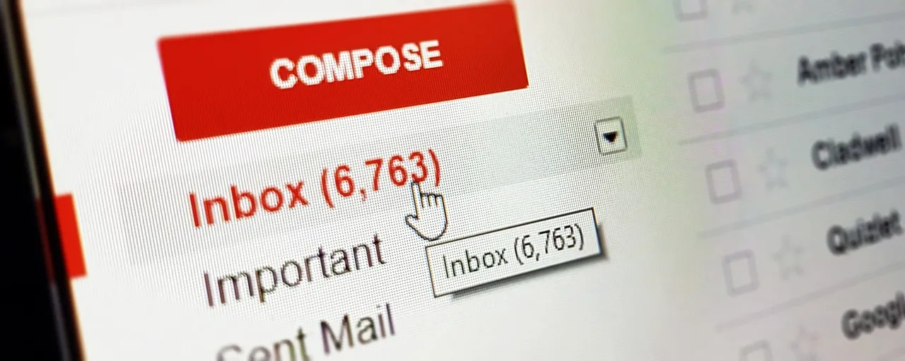 A close-up of an email inbox on a computer screen showing a large unread message count beside the cursor.