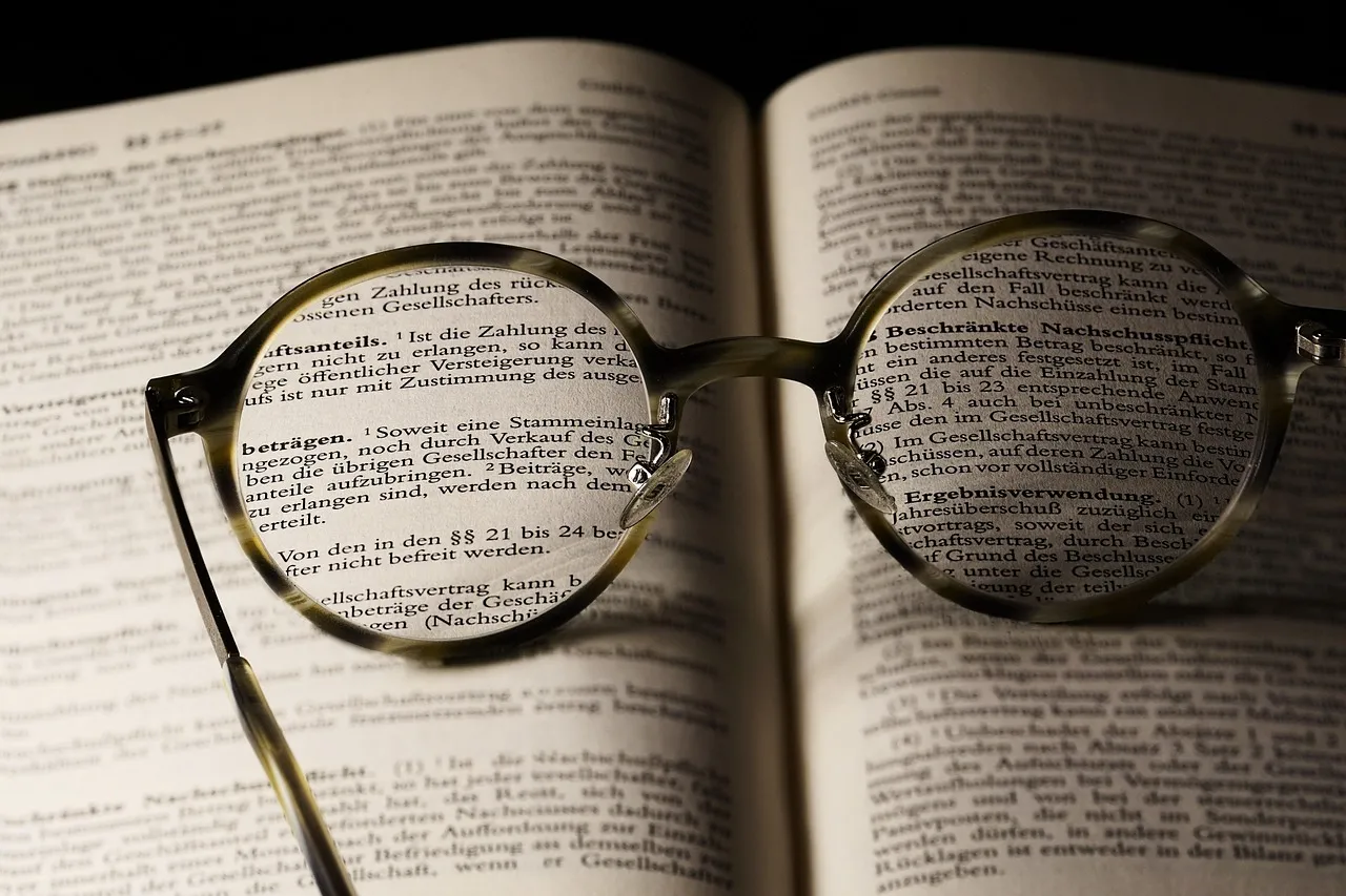 Reading glasses resting on the pages of an open book