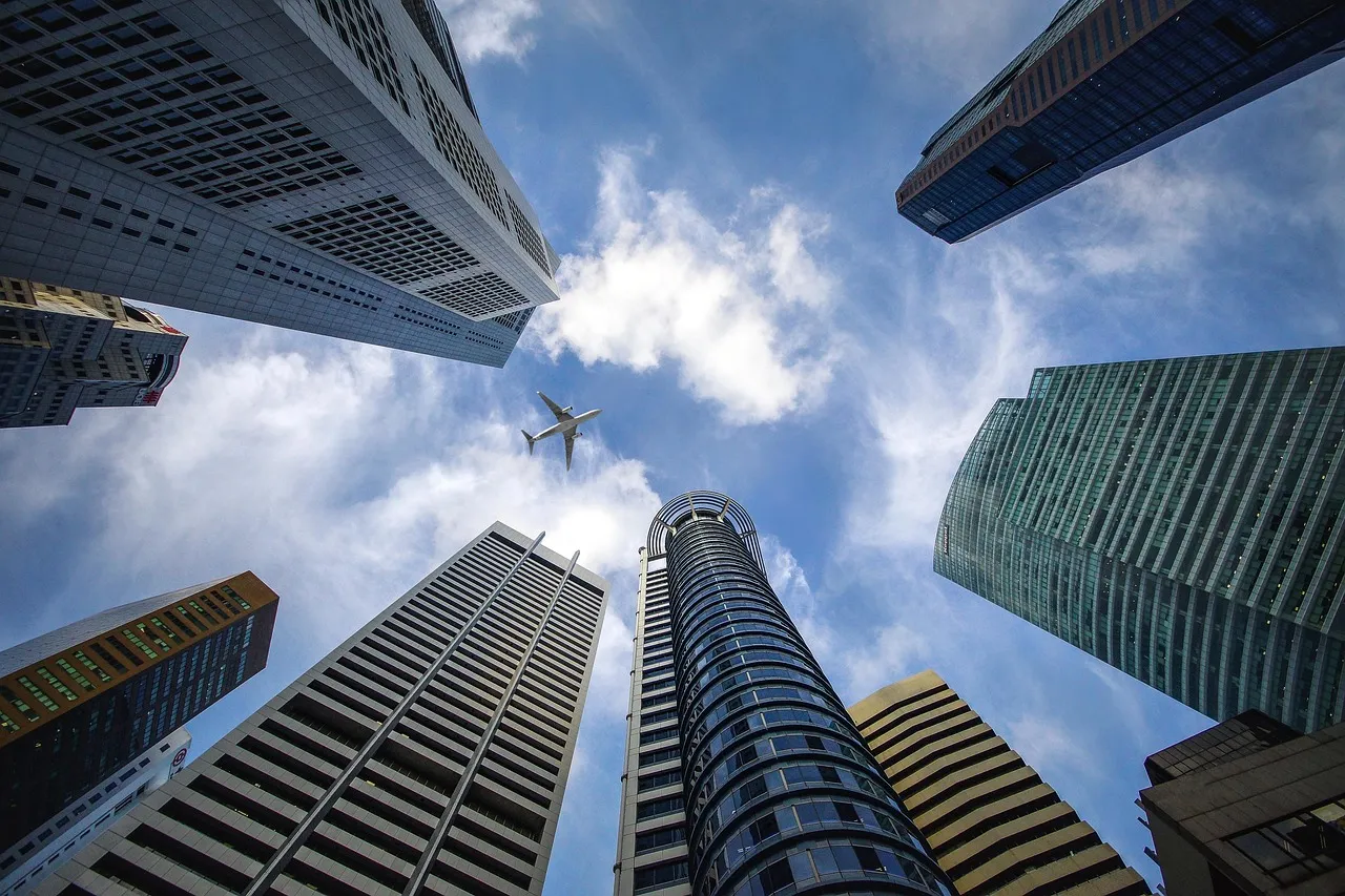 Singapore's financial district skyline of high-rise office towers against the sky.