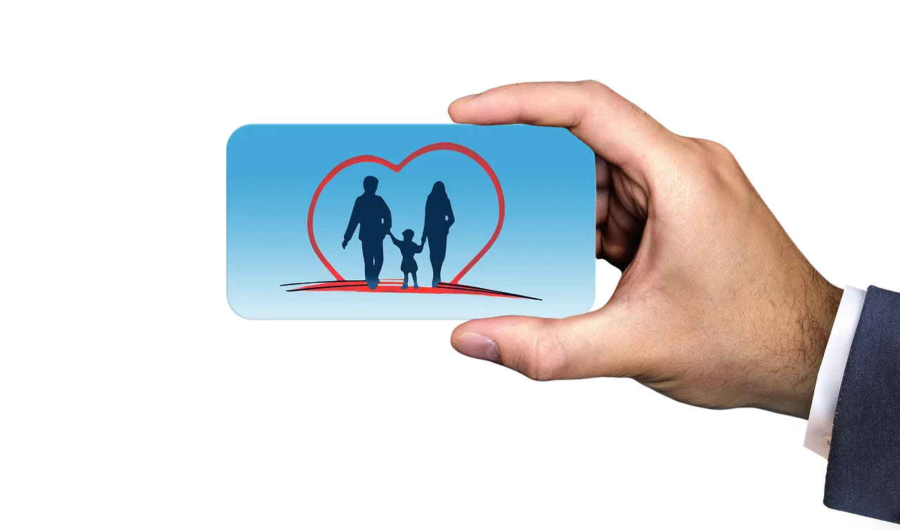 A hand holding a card printed with a family icon