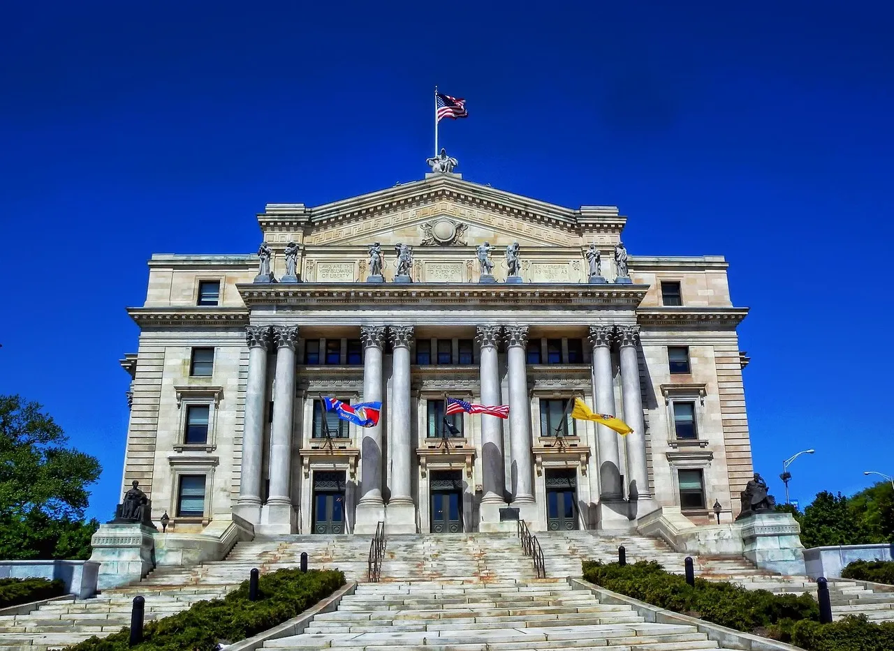 A neoclassical courthouse with a columned portico above a broad flight of steps.