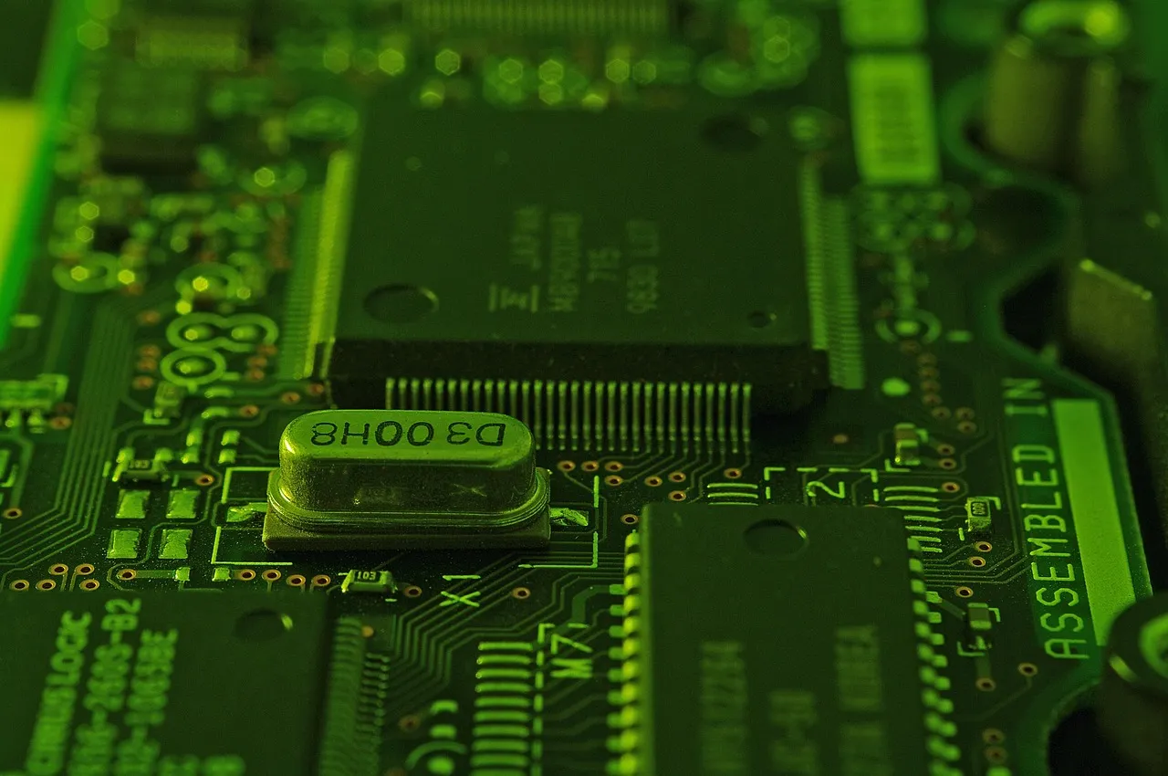 A green circuit board photographed close up, showing memory packages and an assembly marking