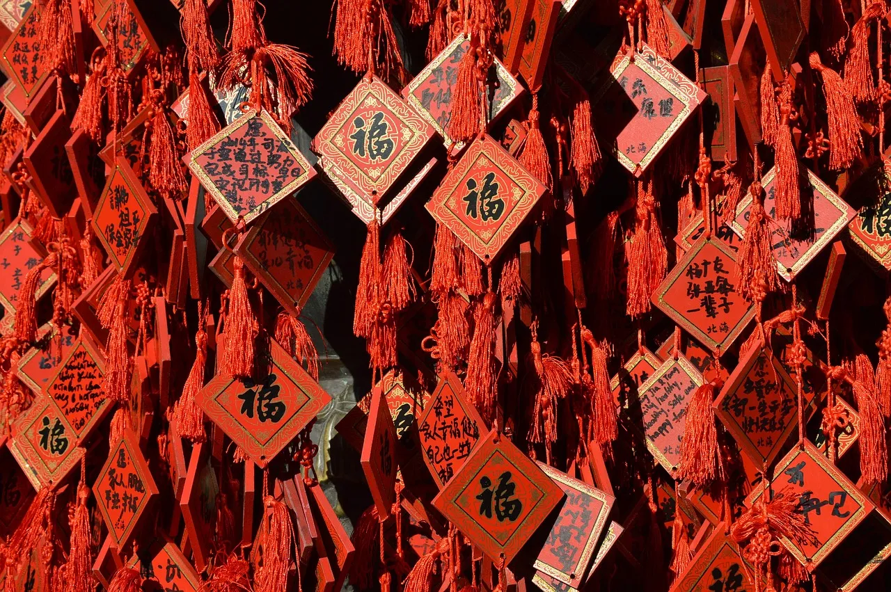 Red wooden prayer plaques marked with the character 福 hanging at a temple