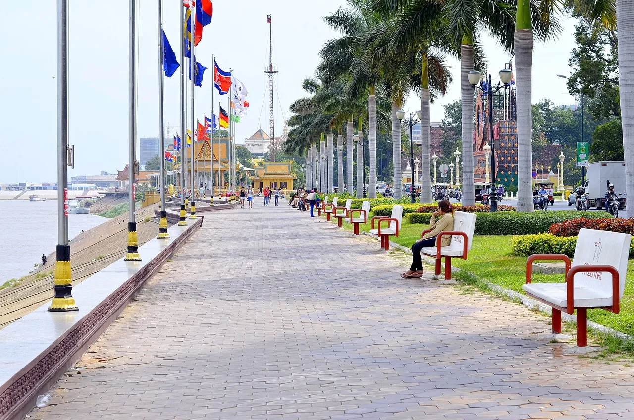 A riverside promenade lined with flags in Cambodia, the country the US report keeps at its lowest trafficking tier