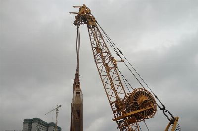 asian construction site, heavy machinery, super lifting power, foundation work, building frenzy