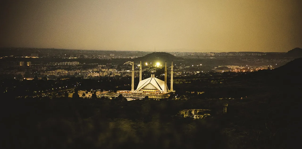 A night view across Islamabad with the city lights spread below the hills