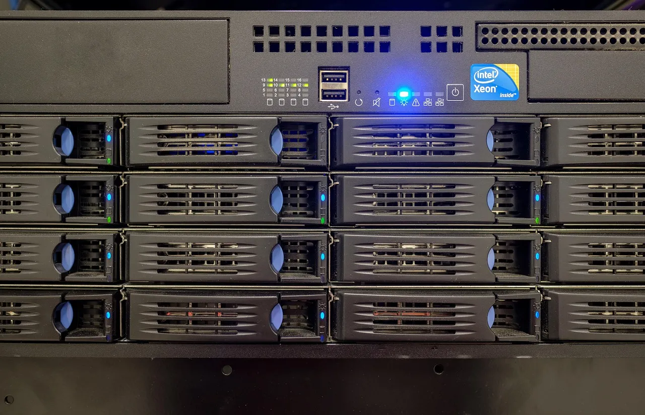 Front panel of a dense rack-mounted storage array, drive bays lit blue