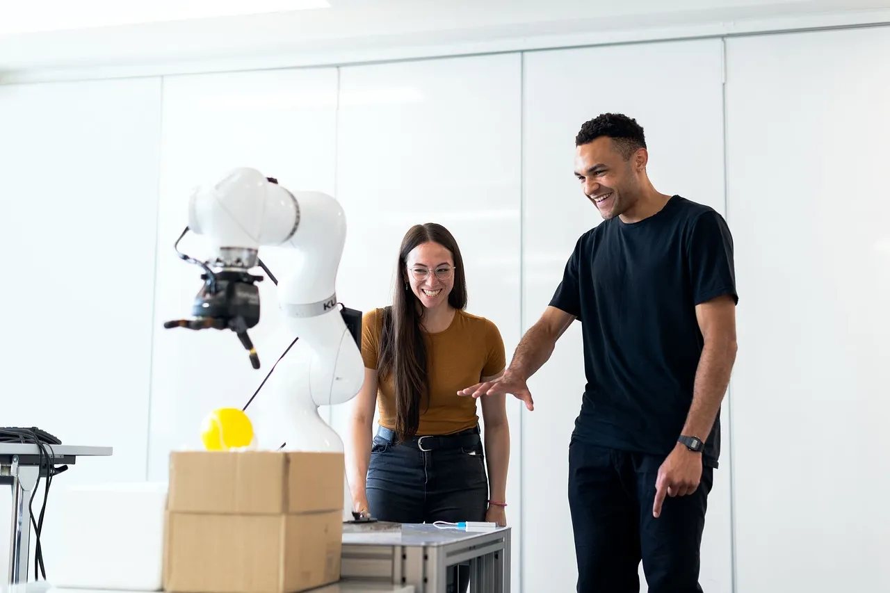 Researchers working with a robot arm in a laboratory, the kind of setting the Unitree G1 EDU is sold into