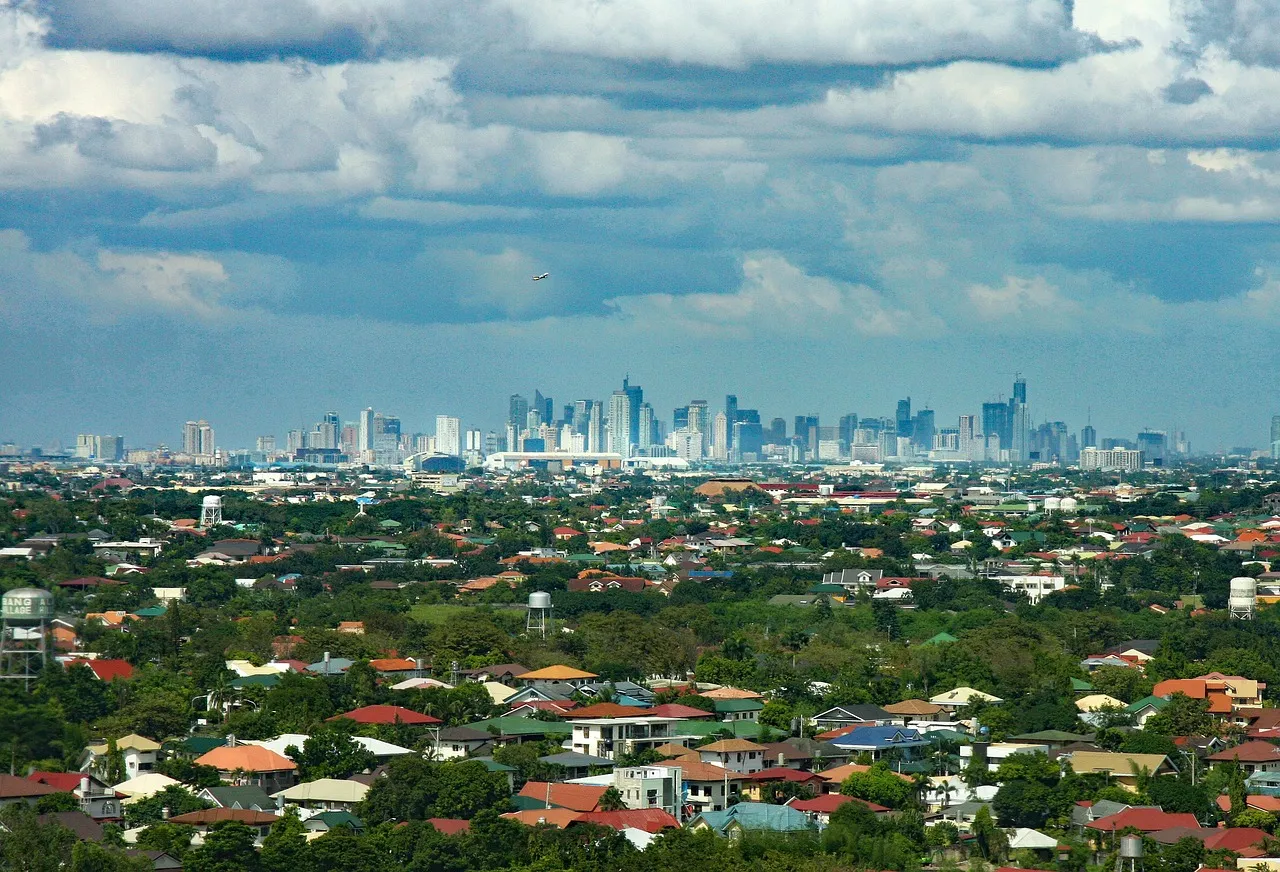 A city skyline in the Philippines beyond low-rise neighbourhoods