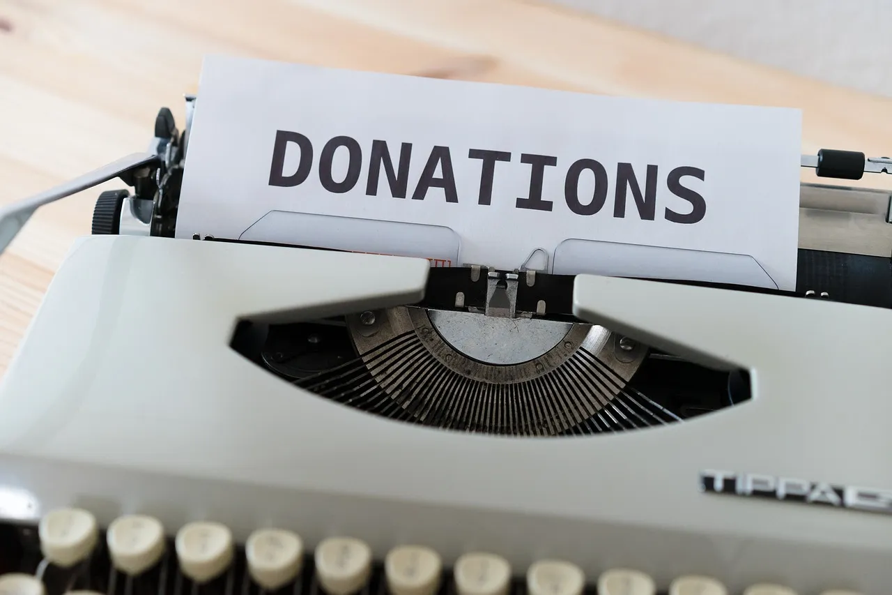 A typewriter with a sheet of paper reading Donations