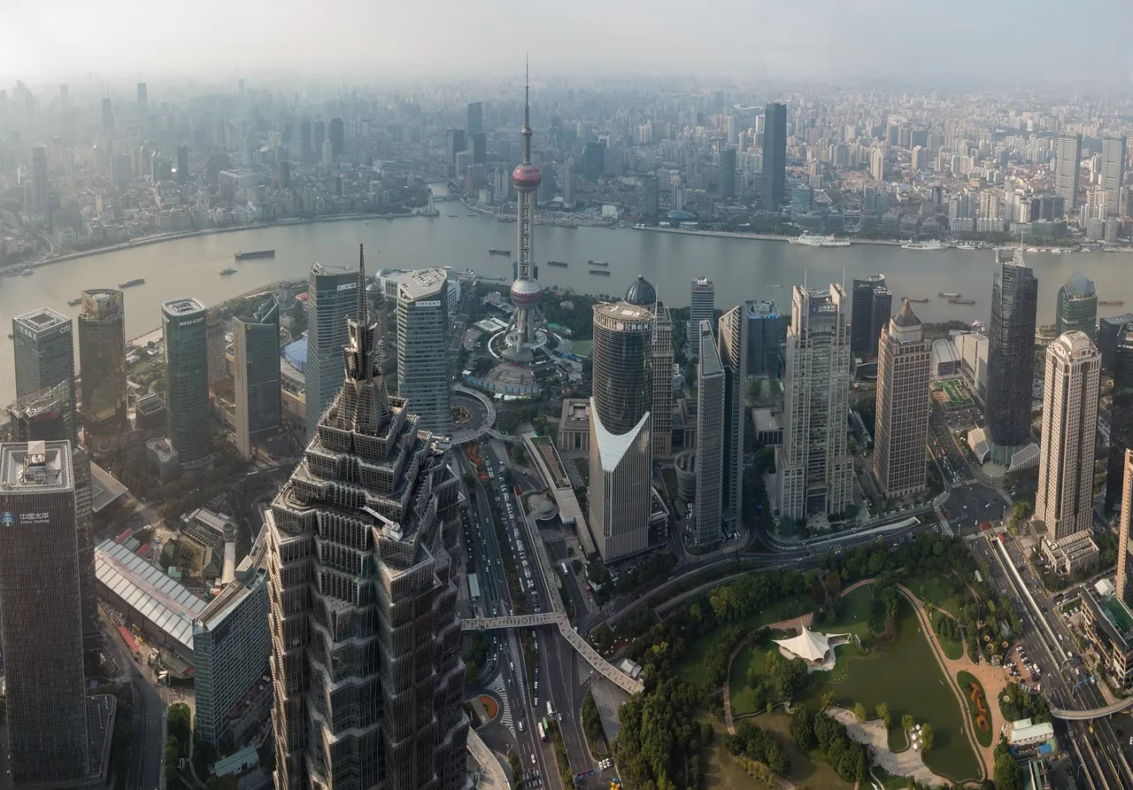 The Shanghai skyline seen from above, with the towers of the Pudong financial district lining the river.