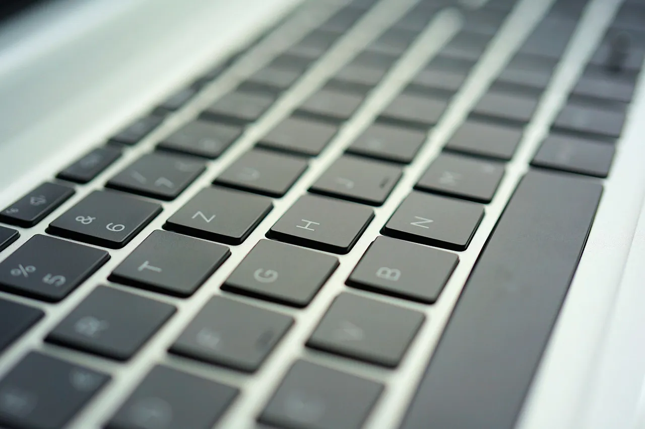A close-up of a laptop keyboard at a shallow angle — illustrating the step this attack depends on, which the victim performs themselves.