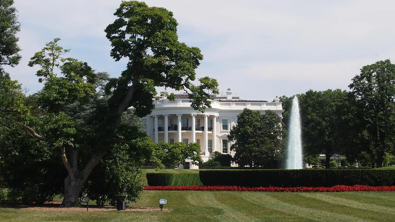 The White House seen across its lawn and trees