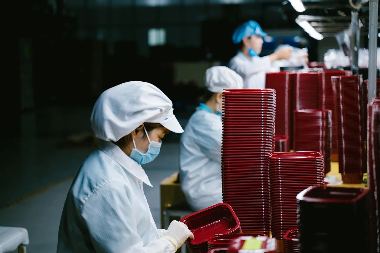 Workers on a production line, the labour a robot tax is intended to make more expensive to replace