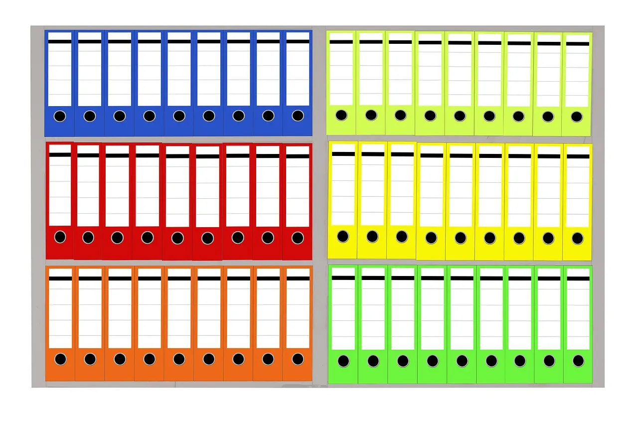 Rows of brightly coloured lever-arch files stacked on office shelves, illustrating a report on customer order records exposed in a data breach.