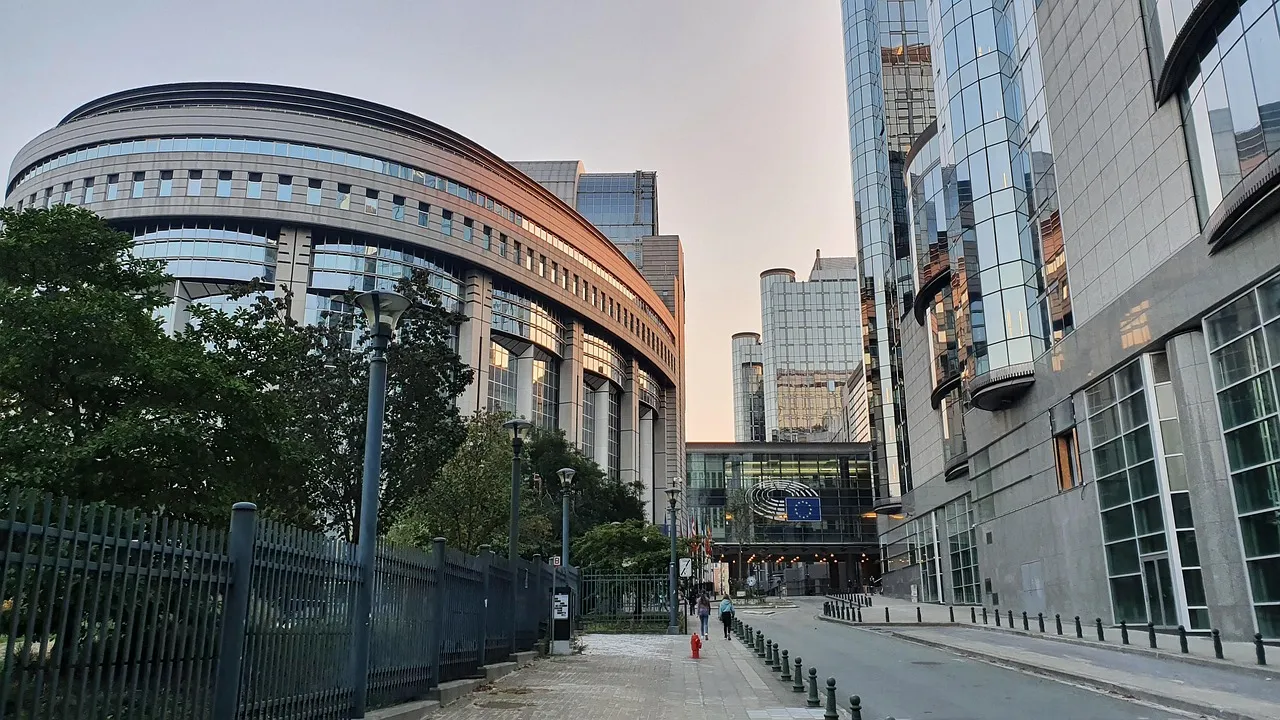 The European Parliament buildings in Brussels at dusk, seen from street level