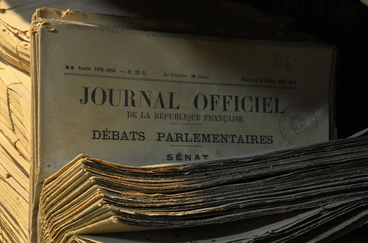 A stack of bound official gazettes, edges frayed, spines stamped with dates