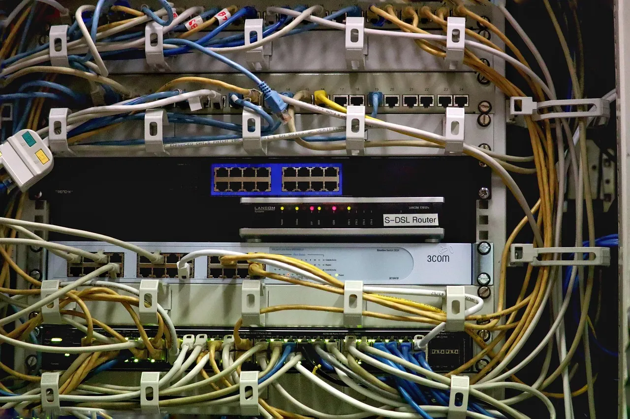 A network switch tangled with patch cables