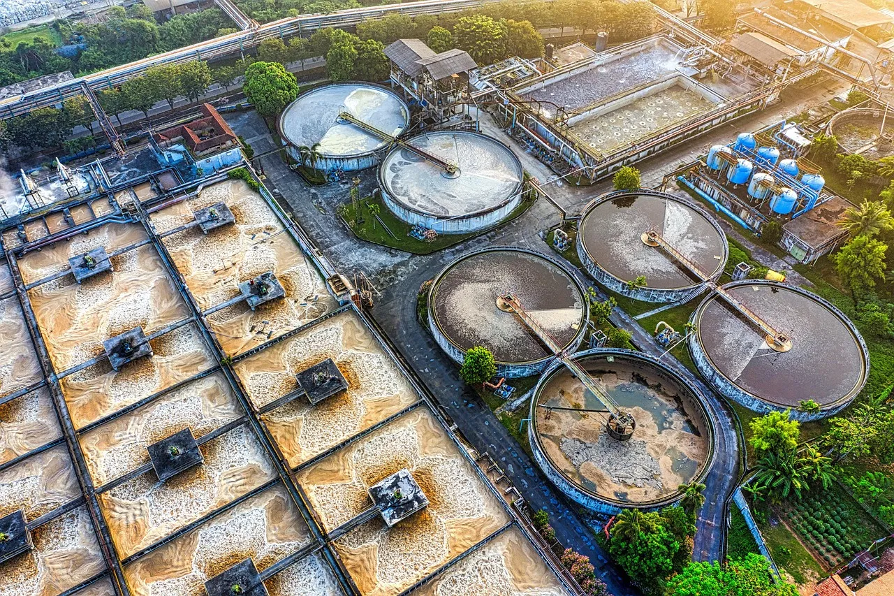 Aerial view of a municipal water treatment works with circular settling tanks — illustrating the kind of small utility reached in this attack.