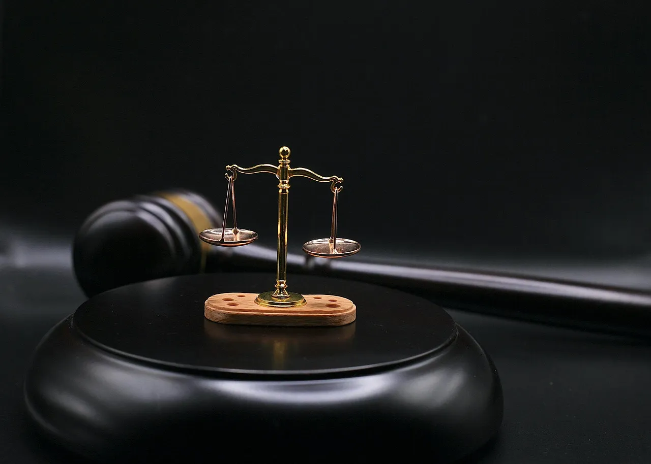 A wooden gavel resting beside legal books — illustrating the appellate ruling that sends these claims toward trial.
