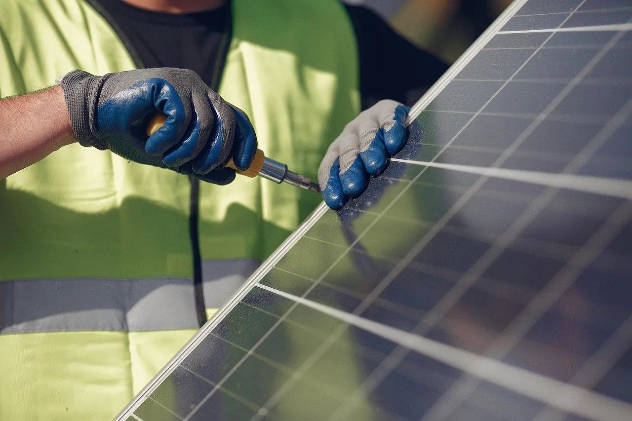 Rows of solar photovoltaic panels on a rooftop.