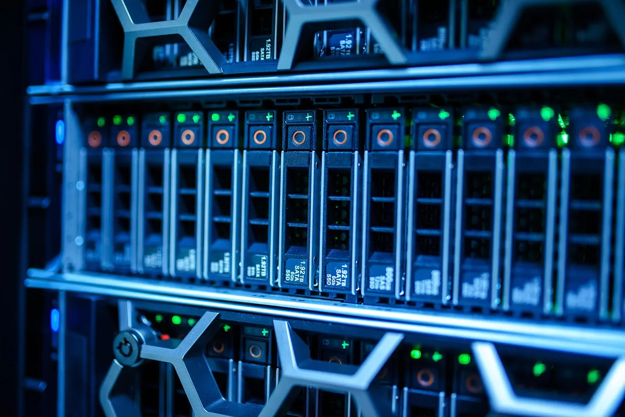 A close view of a server rack lit in blue, showing rows of drive bays and status indicators