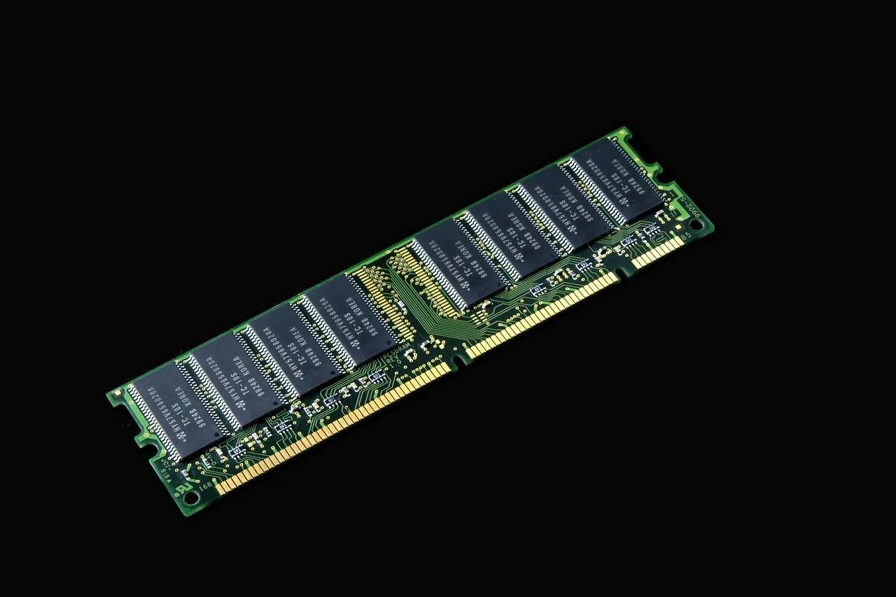 A green computer memory module photographed against a black background.