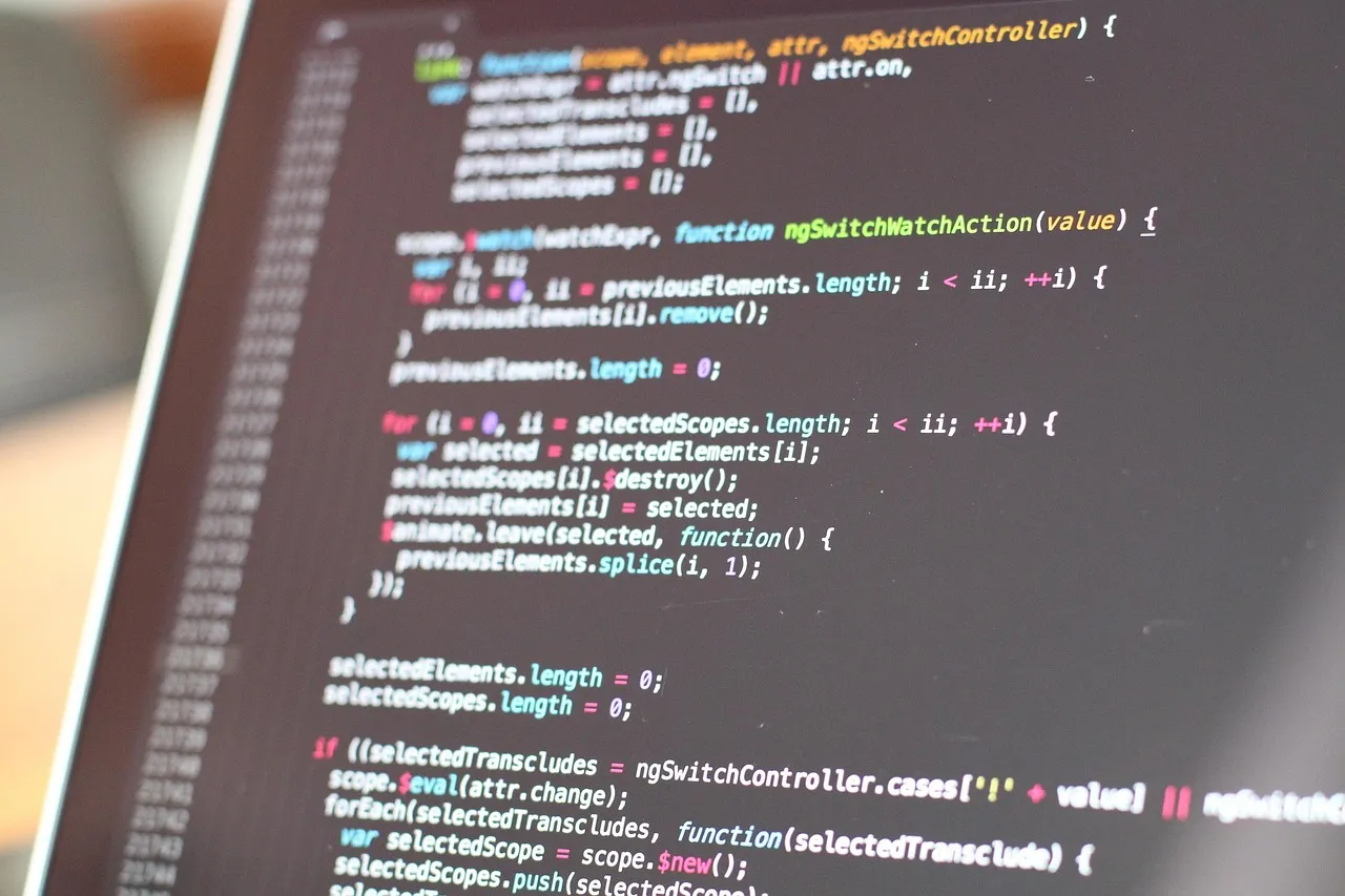 Coloured source code on a dark editor screen, photographed at an angle
