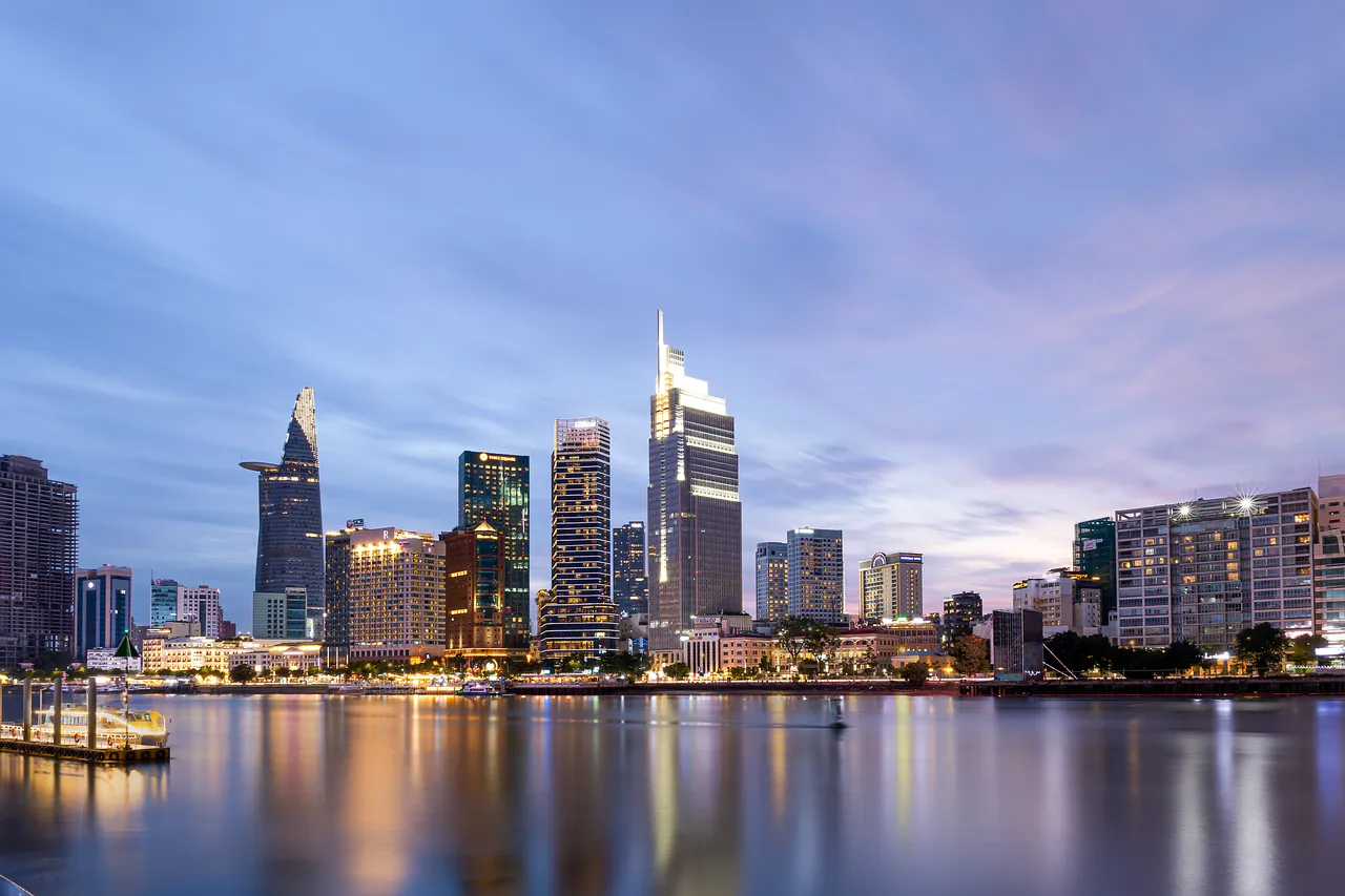 The skyline of Ho Chi Minh City at dusk, seen across the river