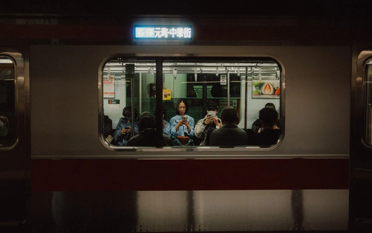 Passengers seen through the window of a commuter train in Japan